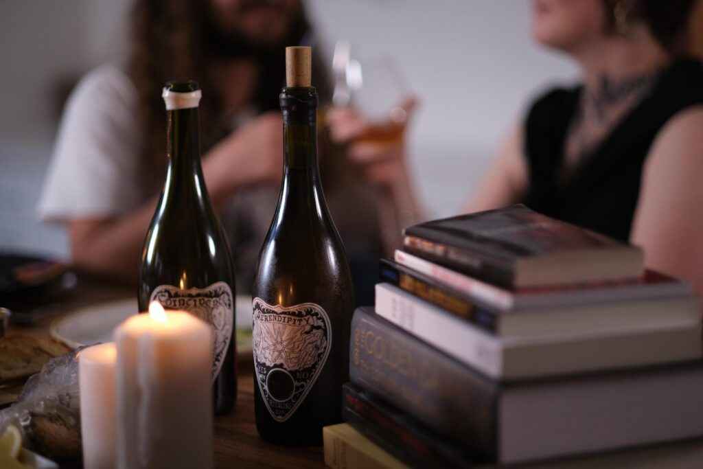 candles, wines books, two people in background talking